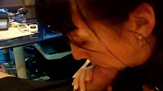 Dark-haired providing a very passionate pov blowjob to her husband on the couch