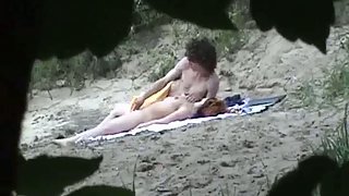 Voyeur camera capturing couple on beach having hump in public