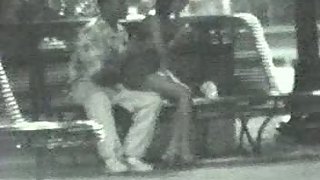 Couple in park after club having romp in public on a bench