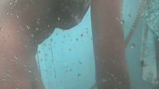 Hot young couple taking an outdoor steamy shower lovemaking
